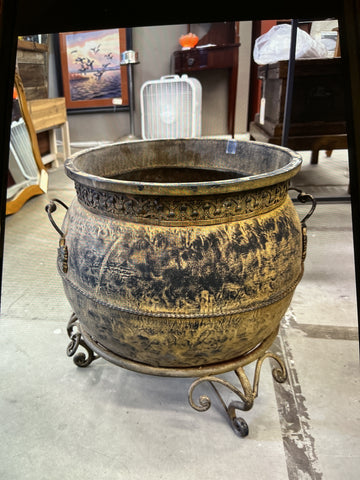 Aluminum planter with engraved decorative bands on wrought iron stand